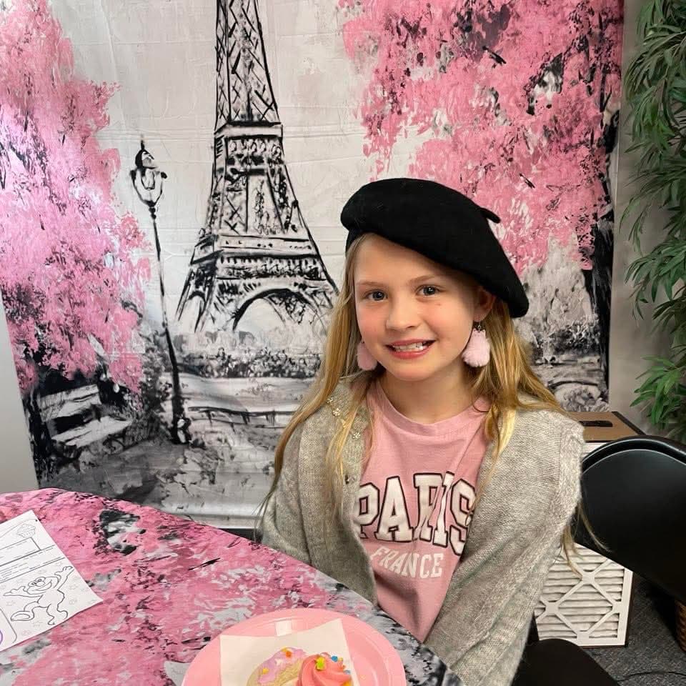 Student at Paris-themed cultural day wearing a beret