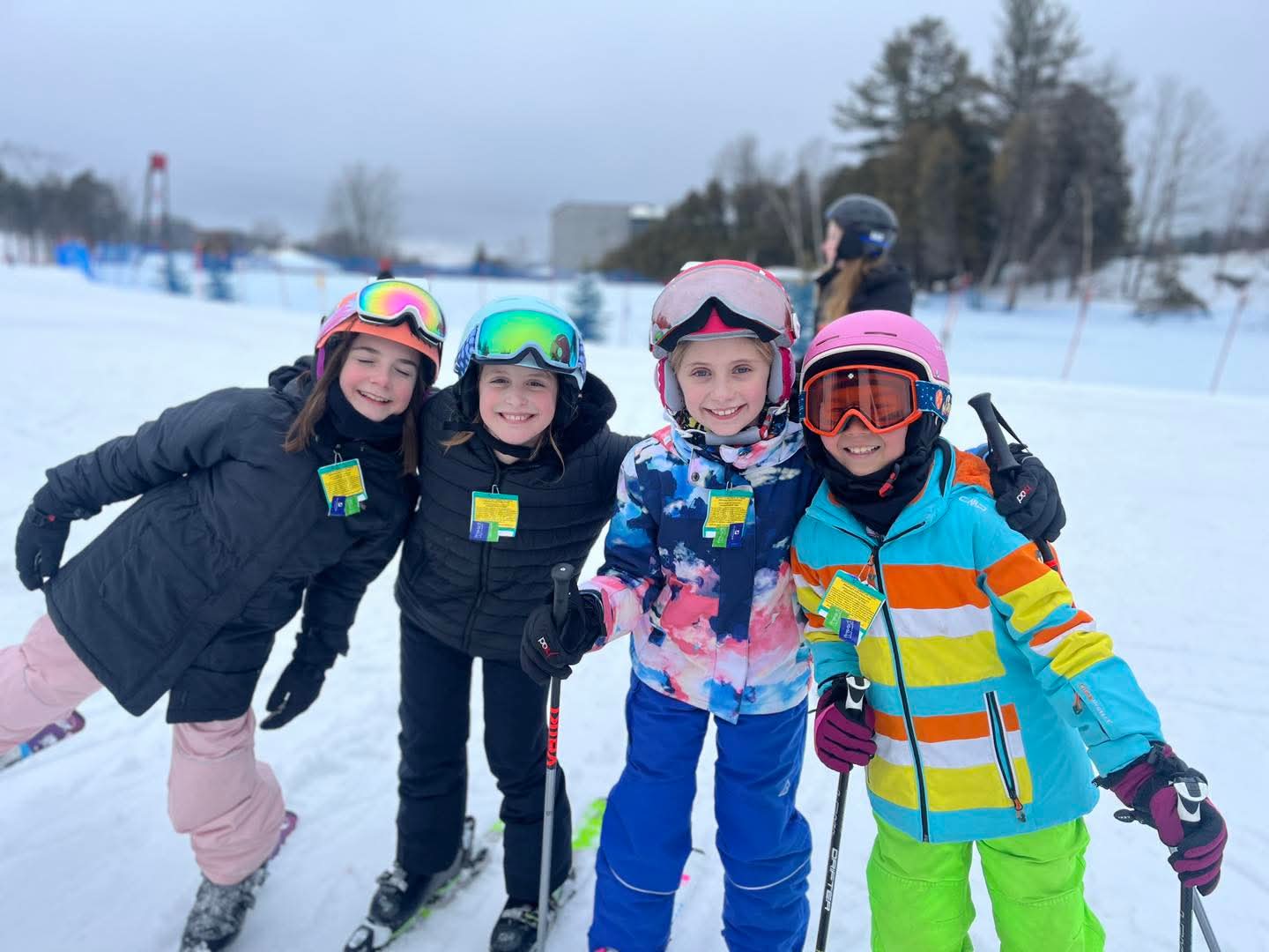 Four girls skiing together on a snowy slope